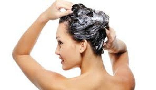 Femeie care spală părul mai rar