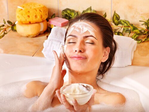 Femeie aplicând măști faciale naturale în timpul băii