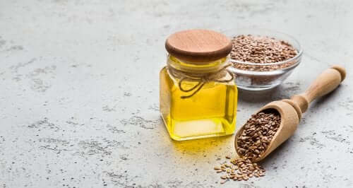 Acidul linoleic conjugat într-un borcan lângă un bol cu grâu