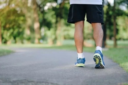 Bărbat care merge în parc pentru a evita stilul de viață sedentar