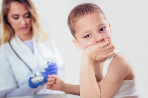Asistentă care verifică nivelul glicemiei la copii