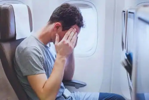 Bărbat care simte stresul în timpul zborului